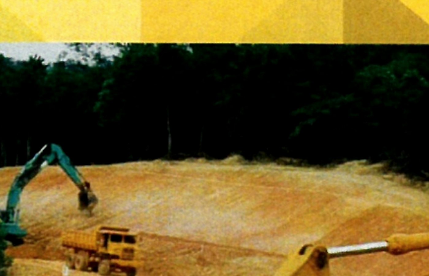 Excavator and tipper lorry carrying out earthworks in Kedah